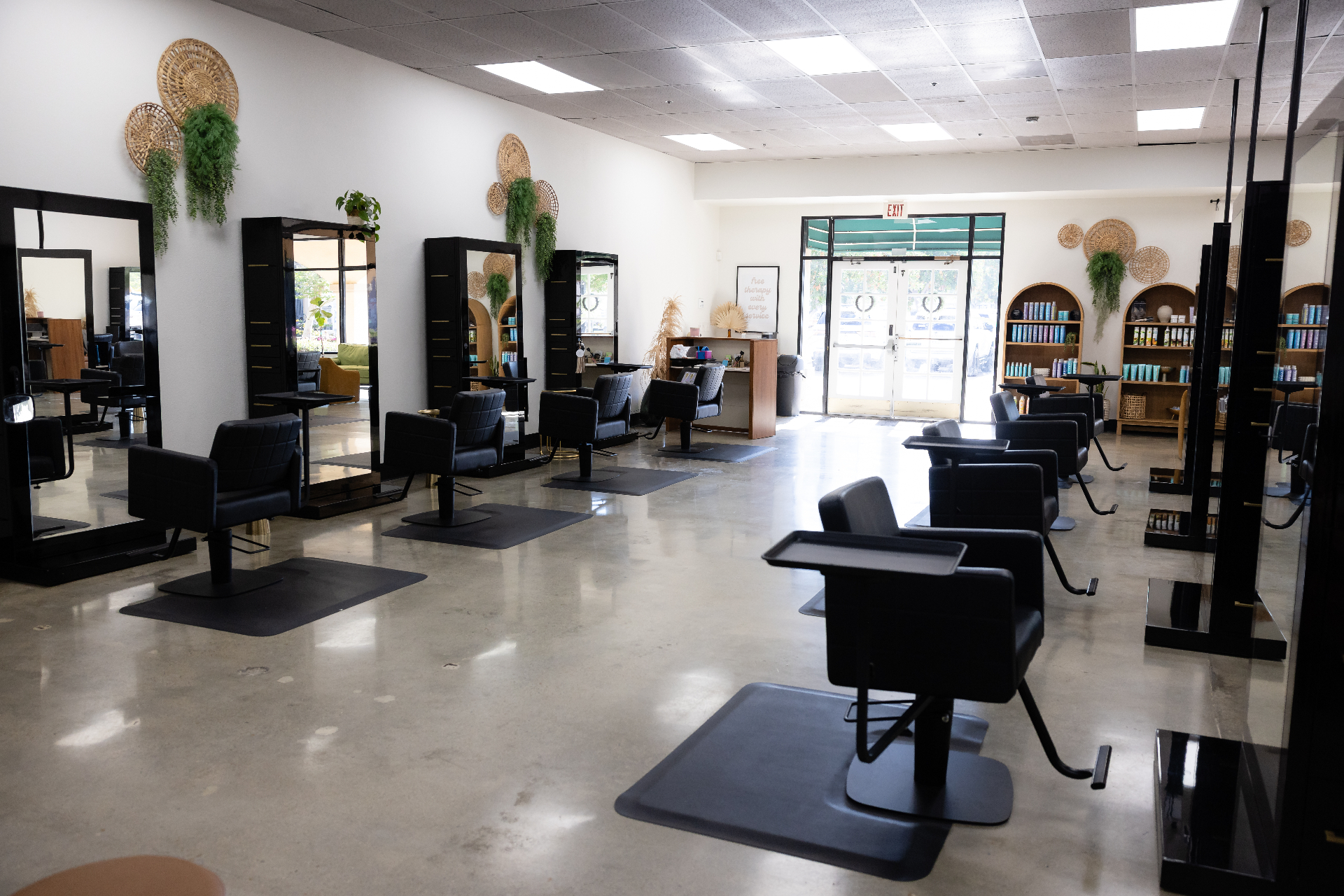 Salon Thrive open floor with stylist chairs, mirrors, and retail shelving